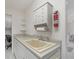 Laundry room with utility sink and storage cabinets at 197 Bunker Rd, Rotonda West, FL 33947