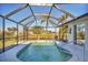 Screened-in pool with backyard and canal view at 197 Bunker Rd, Rotonda West, FL 33947