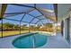 Screened-in pool with backyard and canal view at 197 Bunker Rd, Rotonda West, FL 33947