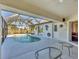 Enclosed pool and patio with glass roof and outdoor furniture at 197 Bunker Rd, Rotonda West, FL 33947