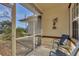 Relaxing screened porch with comfy seating and peaceful views at 197 Bunker Rd, Rotonda West, FL 33947