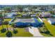 Aerial view of a light blue house with a large yard and solar panels at 221 E Wentworth St, Englewood, FL 34223