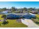 Aerial view of a charming light blue house with a spacious yard at 221 E Wentworth St, Englewood, FL 34223