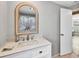 Clean bathroom with white vanity, quartz countertop and decorative mirror at 221 E Wentworth St, Englewood, FL 34223