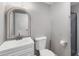 Small bathroom with white vanity, toilet, and shower at 221 E Wentworth St, Englewood, FL 34223