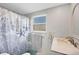 Bathroom with white vanity, shower and decorative shower curtain at 221 E Wentworth St, Englewood, FL 34223