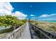 Wooden boardwalk leads to a beautiful beach with blue water and white sand at 221 E Wentworth St, Englewood, FL 34223