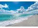 Scenic beach view with clear water and white sand under a bright sky at 221 E Wentworth St, Englewood, FL 34223