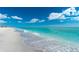 Stunning beach view with clear water, white sand, and people enjoying the day at 221 E Wentworth St, Englewood, FL 34223