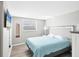 Bedroom with a queen-size bed and light blue bedding at 221 E Wentworth St, Englewood, FL 34223