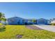 Light blue house with a screened porch and a spacious yard at 221 E Wentworth St, Englewood, FL 34223