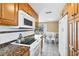 Kitchen with wood cabinets, granite countertops and white appliances at 221 E Wentworth St, Englewood, FL 34223
