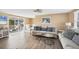 Bright living room with light wood floors and comfortable sofas at 221 E Wentworth St, Englewood, FL 34223