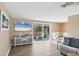Open living room and dining area with sliding glass doors to a patio at 221 E Wentworth St, Englewood, FL 34223