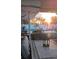 Relaxing view of the pool area at sunset, with patio furniture and string lights at 221 E Wentworth St, Englewood, FL 34223