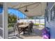 Screened patio with table, chairs, and string lights at 221 E Wentworth St, Englewood, FL 34223