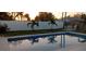 Inviting swimming pool in a backyard setting with palm trees and white fence at 221 E Wentworth St, Englewood, FL 34223