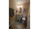 Clean bathroom with toilet, vanity, and updated flooring at 244 Saint Augustine Ave # 102, Venice, FL 34285