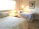 Guest bedroom with two twin beds and light decor at 244 Saint Augustine Ave # 102, Venice, FL 34285