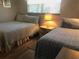 Guest bedroom with two twin beds and light decor at 244 Saint Augustine Ave # 102, Venice, FL 34285