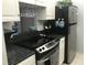 Modern kitchen with stainless steel appliances and granite countertops at 244 Saint Augustine Ave # 102, Venice, FL 34285