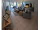 Living area featuring a sofa, coffee table, and access to patio at 244 Saint Augustine Ave # 102, Venice, FL 34285