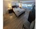 King-size bed, light wood floors, and ceiling fan in main bedroom at 244 Saint Augustine Ave # 102, Venice, FL 34285