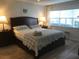 Main bedroom with king bed and light wood floors at 244 Saint Augustine Ave # 102, Venice, FL 34285
