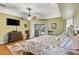 Spacious primary bedroom with hardwood floors, ceiling fan, and sliding doors leading to the pool at 249 Sportsman Rd, Rotonda West, FL 33947