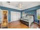 Serene bedroom with hardwood floors, a ceiling fan and access to a hallway at 249 Sportsman Rd, Rotonda West, FL 33947