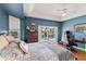 Peaceful bedroom with hardwood floors, a ceiling fan and views of the pool at 249 Sportsman Rd, Rotonda West, FL 33947