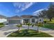 Single-story home with a three-car garage and circular driveway at 249 Sportsman Rd, Rotonda West, FL 33947