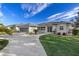Home's exterior, featuring a two-car garage and landscaped yard at 249 Sportsman Rd, Rotonda West, FL 33947