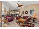 Open living room with leather furniture and ceiling fan at 249 Sportsman Rd, Rotonda West, FL 33947