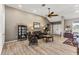 Living area with hardwood floors, leather couch, and ceiling fan at 249 Sportsman Rd, Rotonda West, FL 33947