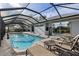 Spacious pool and patio with lounge chairs and a screened enclosure at 249 Sportsman Rd, Rotonda West, FL 33947