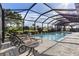 Relaxing poolside patio with lounge chairs under a screened enclosure at 249 Sportsman Rd, Rotonda West, FL 33947