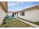 Backyard with grassy area and teal drainage pipe at 255 Boundary Blvd # 104, Rotonda West, FL 33947