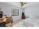 Bedroom with a bed, desk, and window overlooking the backyard at 255 Boundary Blvd # 104, Rotonda West, FL 33947