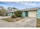 Exterior of light teal home with attached garage and partial view of driveway at 255 Boundary Blvd # 104, Rotonda West, FL 33947