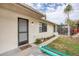 Exterior view showing gray door and walkway at 255 Boundary Blvd # 104, Rotonda West, FL 33947