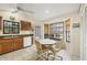 Bright kitchen with wood cabinets, tiled floor, and a built-in breakfast nook at 255 Boundary Blvd # 104, Rotonda West, FL 33947