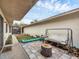Side yard with tiled patio, hanging bench, and garden at 255 Boundary Blvd # 104, Rotonda West, FL 33947