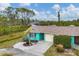 Aerial view showcasing a teal home and its surrounding landscape at 255 Boundary Blvd # 105, Rotonda West, FL 33947