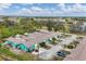 Aerial view showing a row of teal houses in a neighborhood setting at 255 Boundary Blvd # 105, Rotonda West, FL 33947