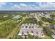Aerial perspective of multiple teal homes within a residential community at 255 Boundary Blvd # 105, Rotonda West, FL 33947