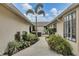 Landscaped backyard with walkway leading to hot tub area at 255 Boundary Blvd # 105, Rotonda West, FL 33947