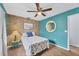 Bright guest bedroom with teal walls, tiled floors, and tropical decor at 255 Boundary Blvd # 105, Rotonda West, FL 33947