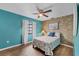 Guest bedroom with teal walls, tiled floors, and tropical-themed bedding at 255 Boundary Blvd # 105, Rotonda West, FL 33947