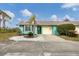 Cute teal home with a one-car garage and well-maintained landscaping at 255 Boundary Blvd # 105, Rotonda West, FL 33947